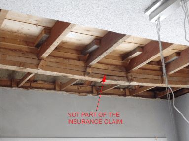 exposed wood beam in ceiling of home.
