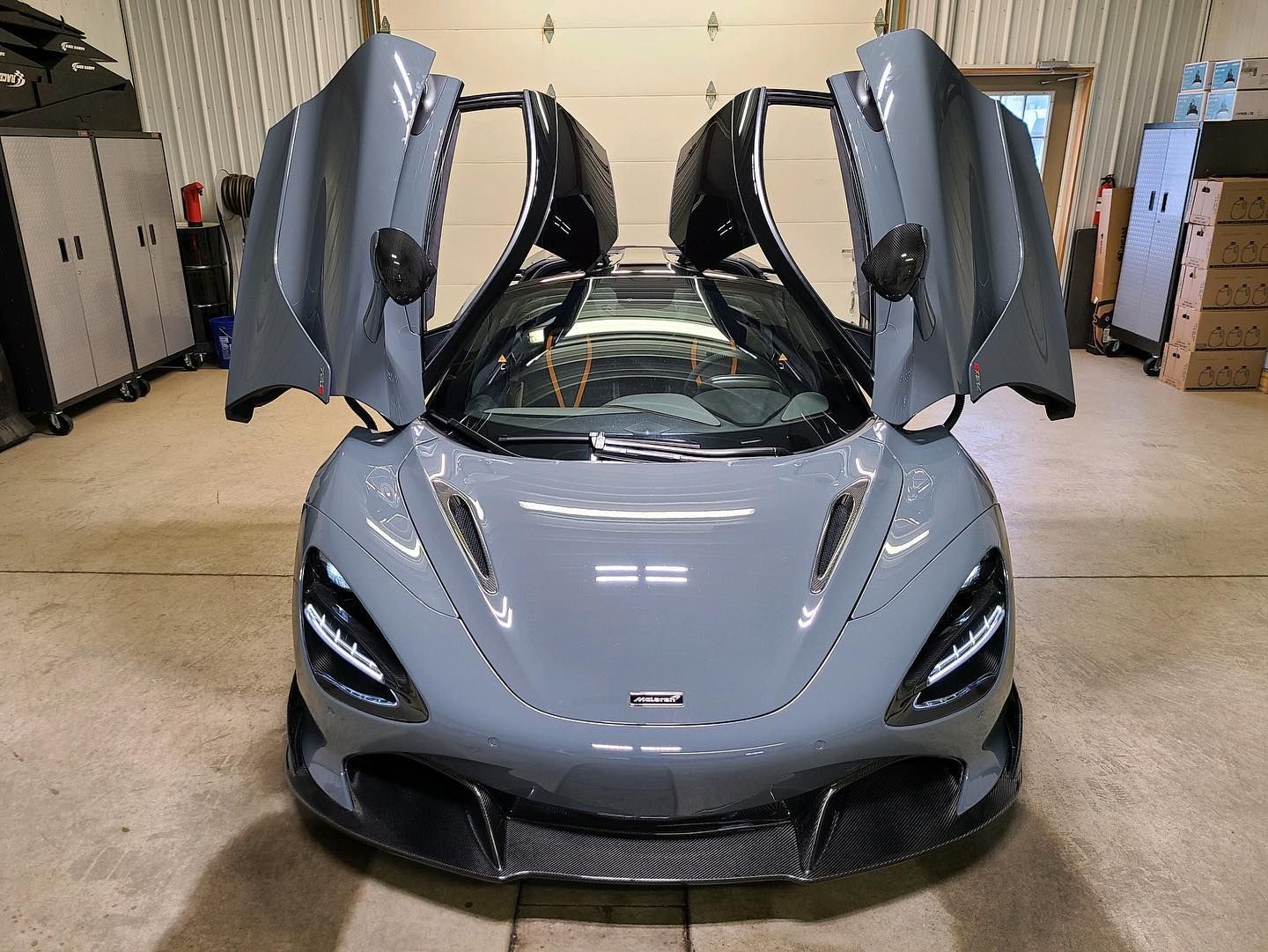 Gray car parked with butterfly doors open