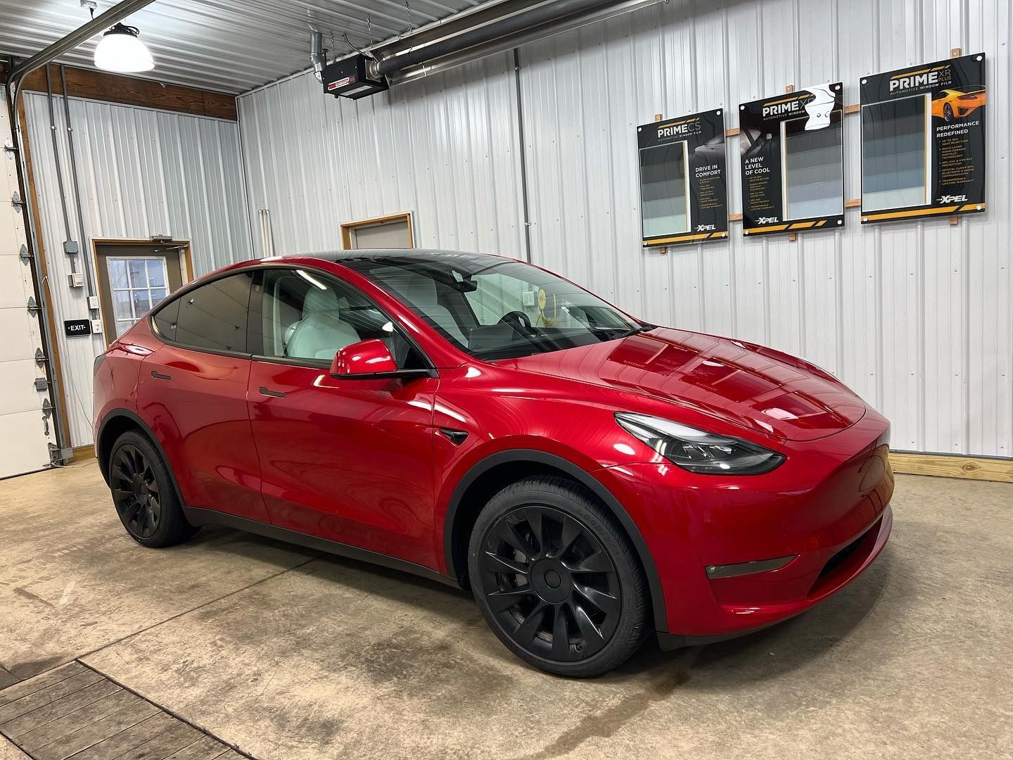 red Tesla car parked inside the shop