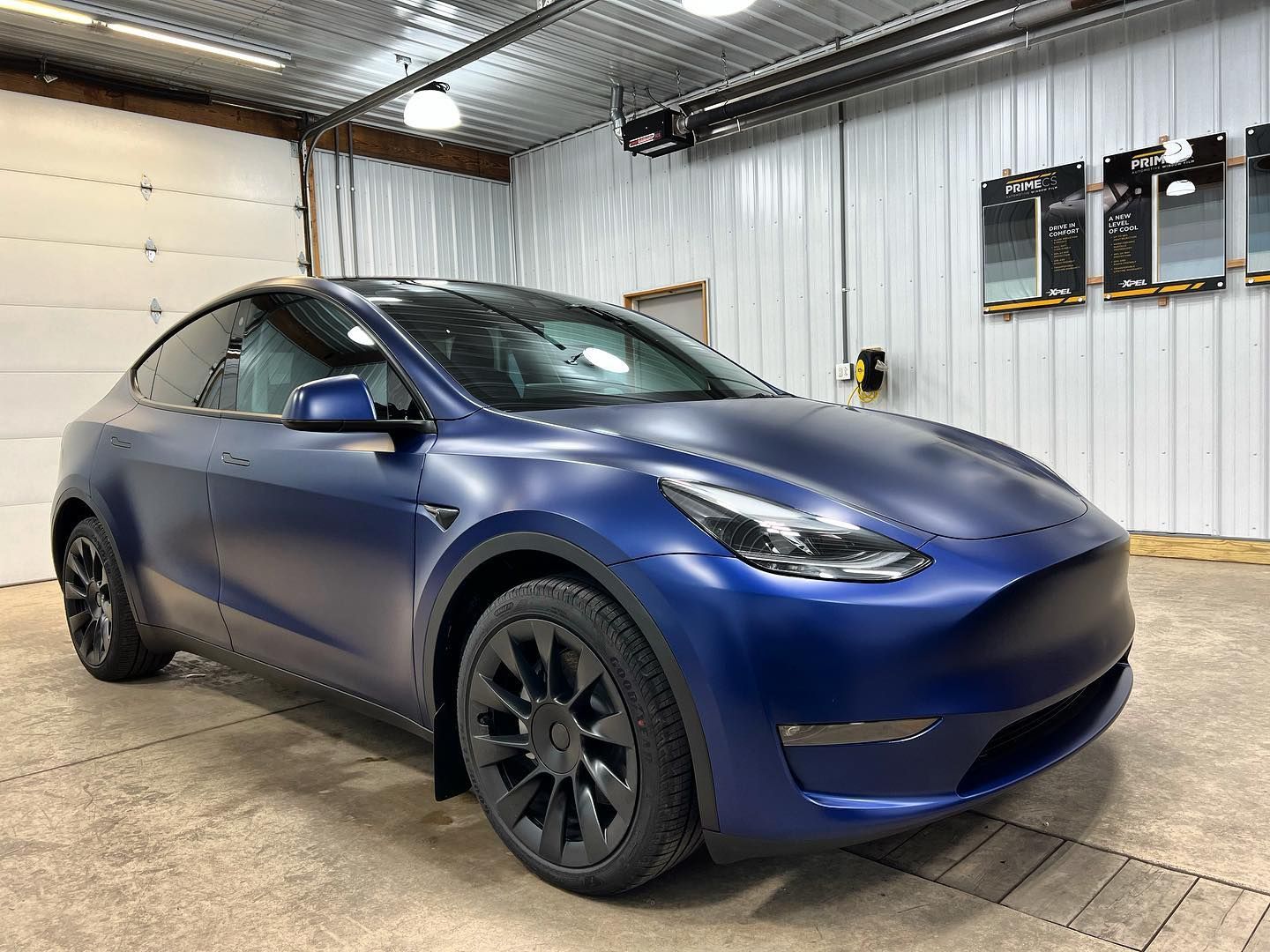 Blue Tesla car parked inside the shop