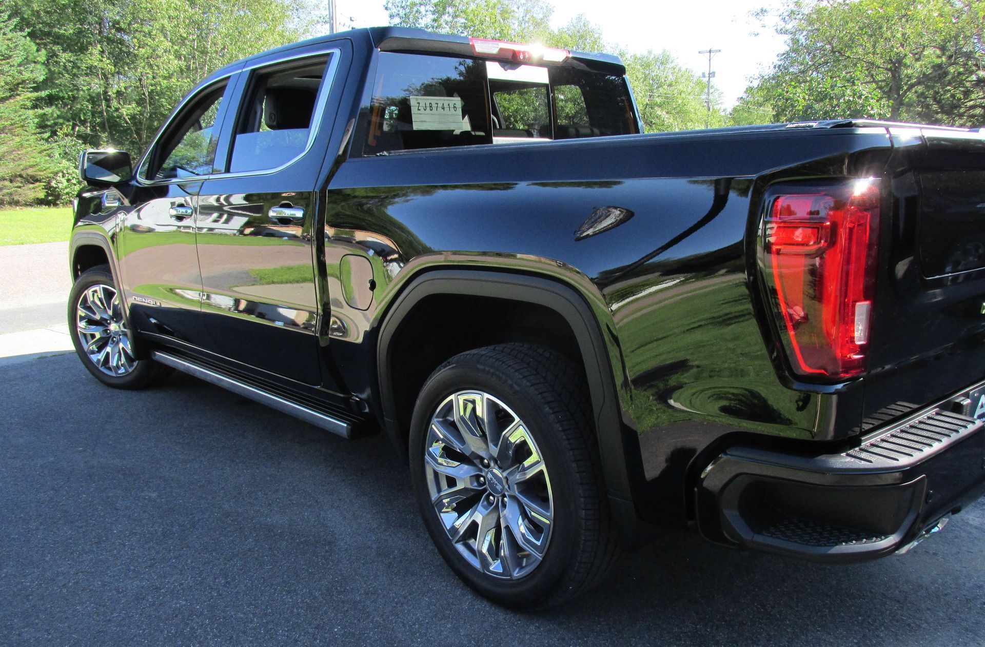 A black pickup truck is parked on the side of the road.