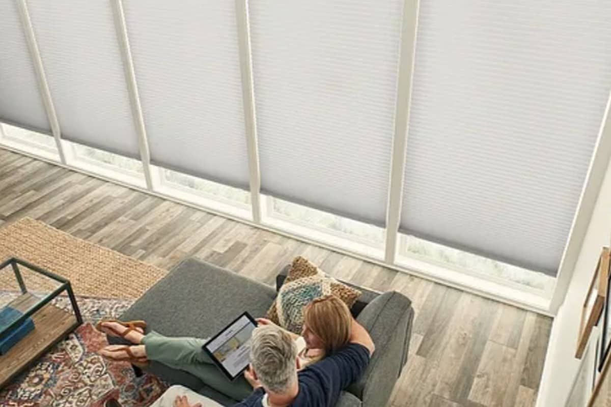 Two people sitting near windows with Graber® Cellular Shades near Kalispell, Montana (MT)