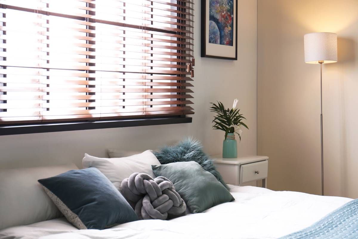 A modern bedroom with wood blinds at The Blind Guy Kalispell near Flathead Valley, Montana (MT)