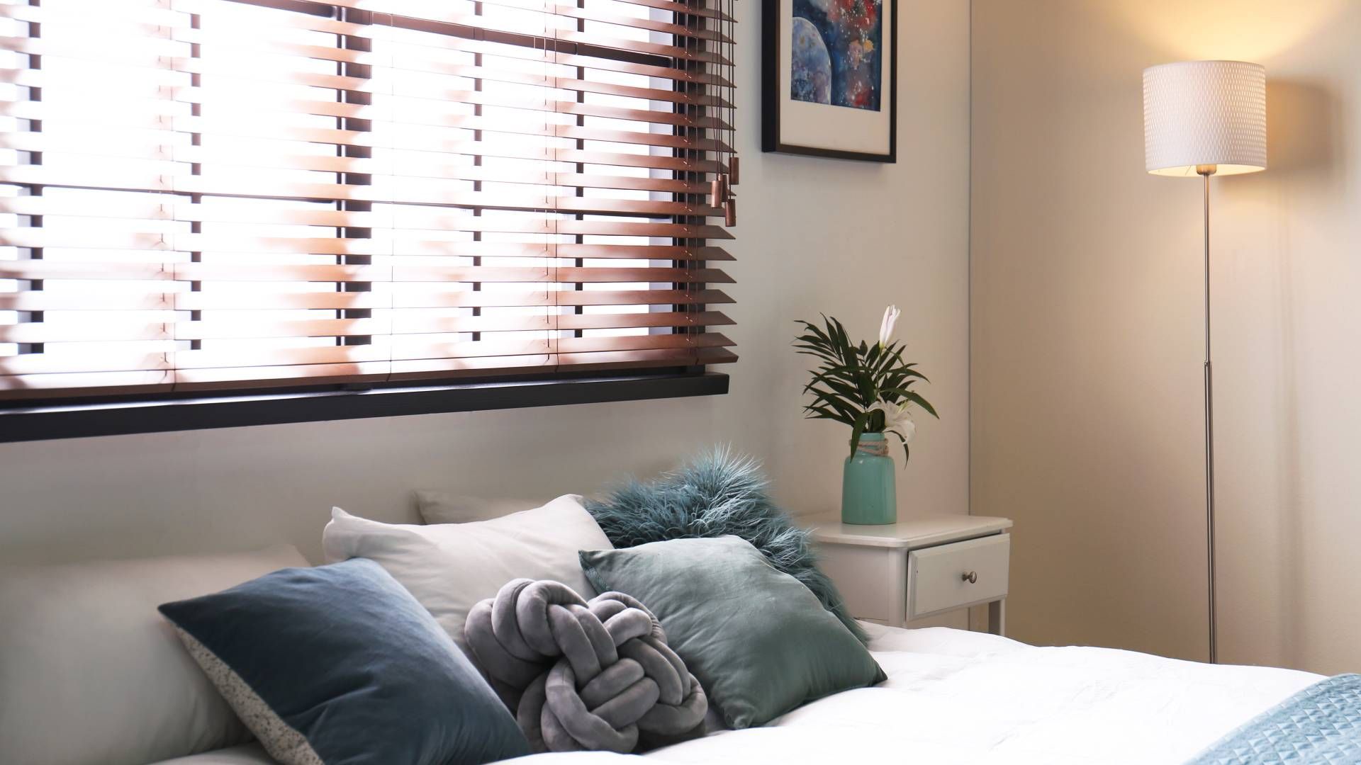 A modern bedroom with wood blinds at The Blind Guy Kalispell near Flathead Valley, Montana (MT)