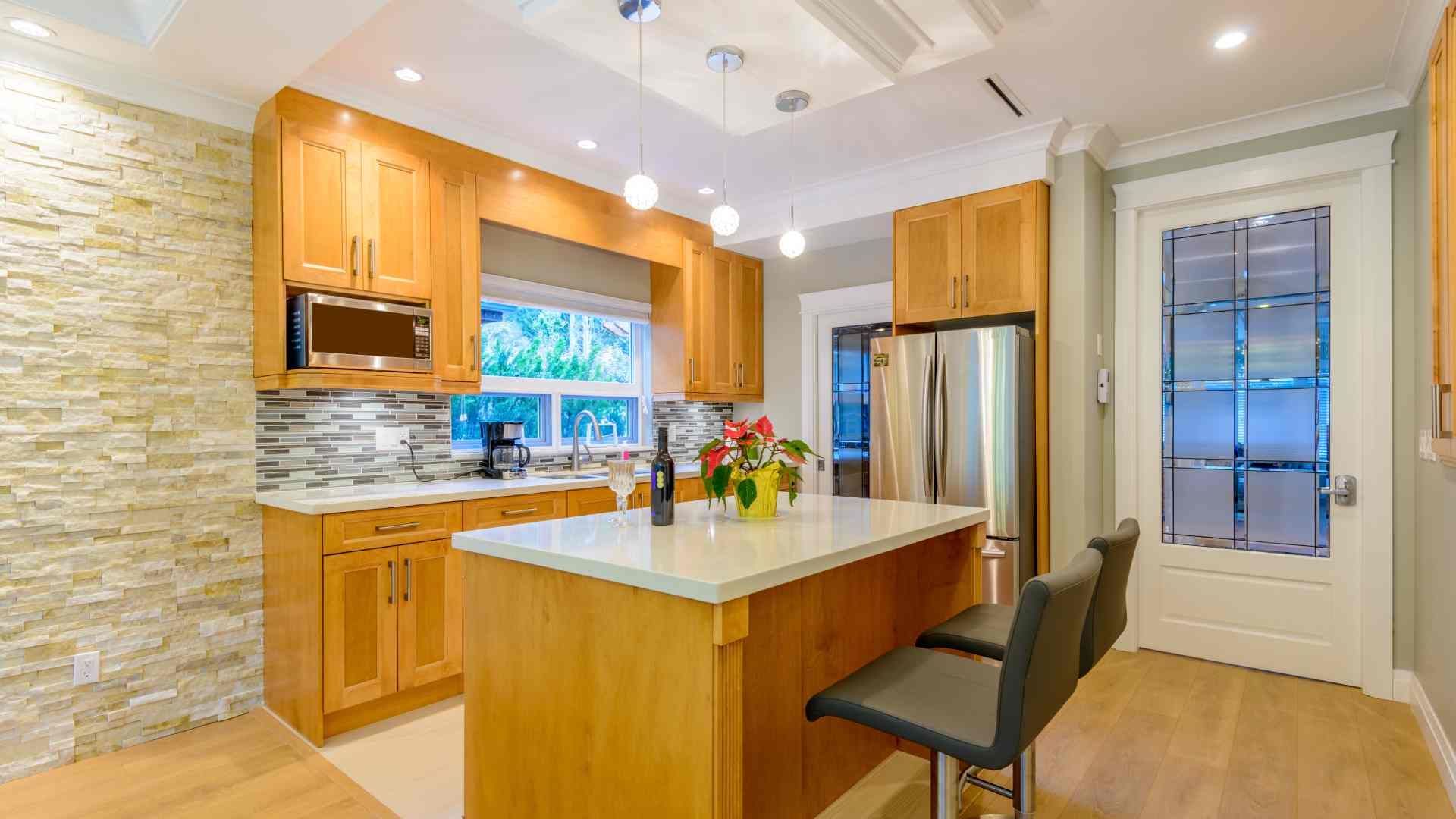 A luxury kitchen with wood and stone elements and a large window near the sink at The Blind Guy