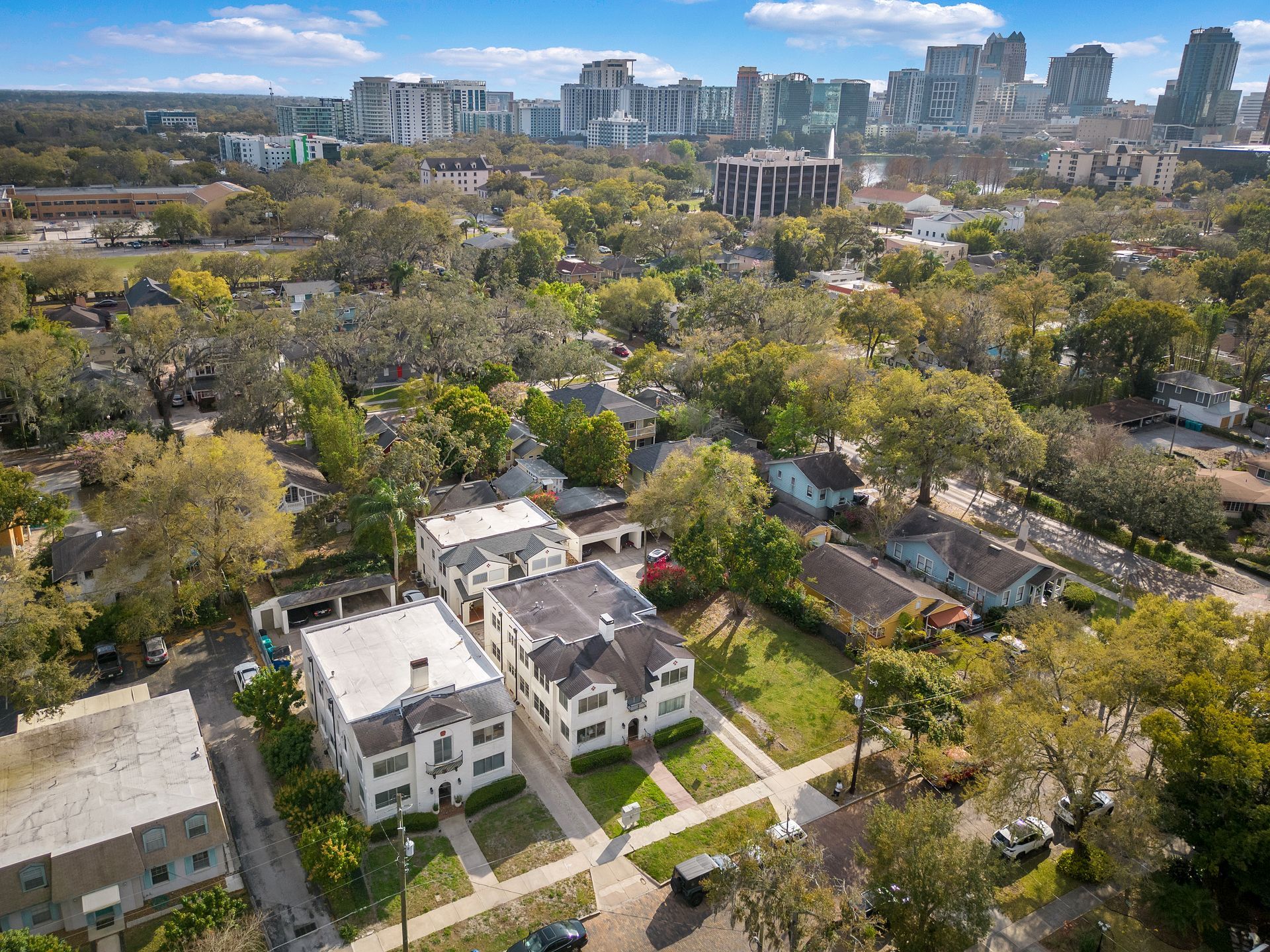 An aerial view of a residential area with a city in the background.