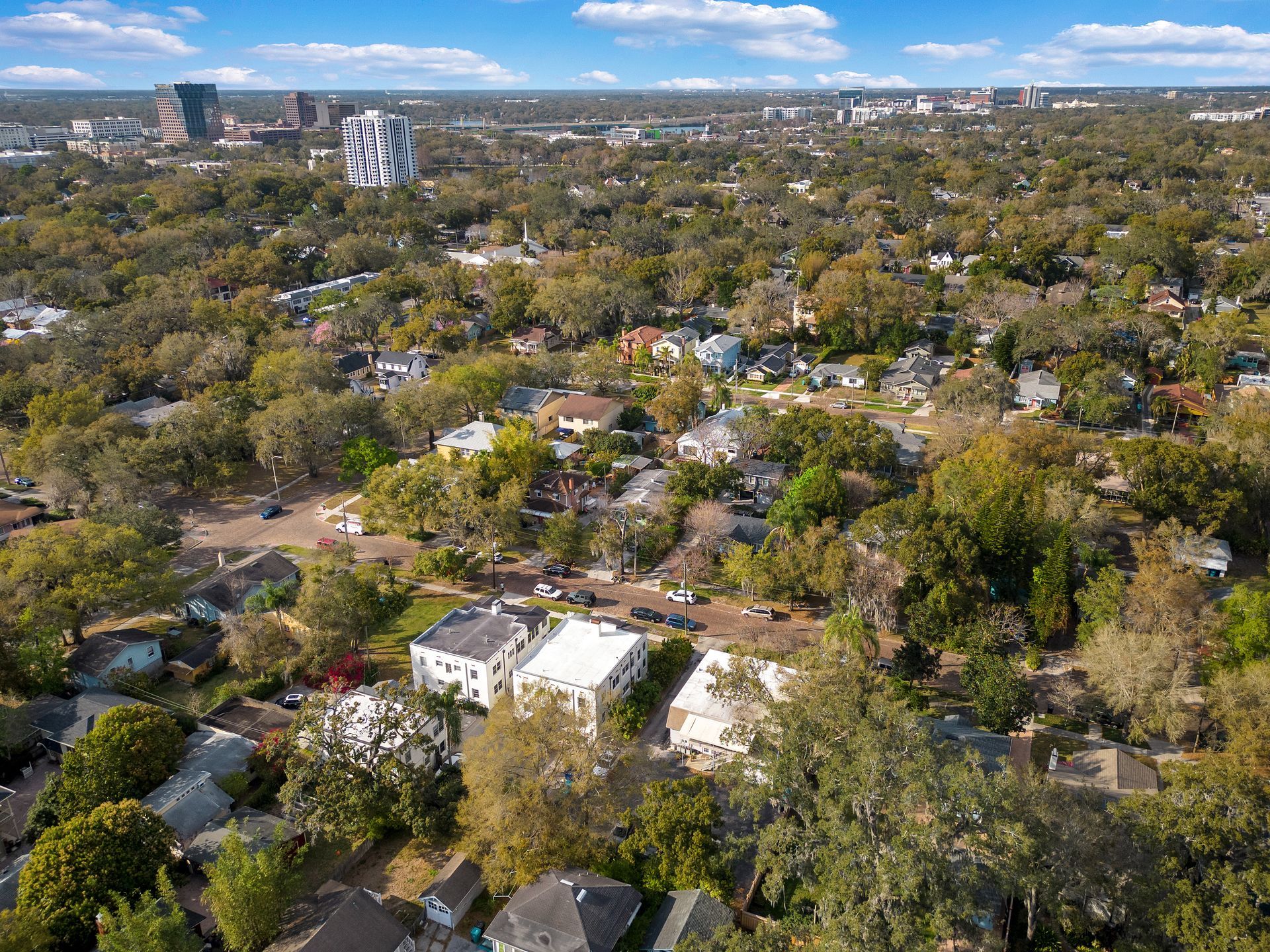 An aerial view of a residential area filled with lots of trees and houses.