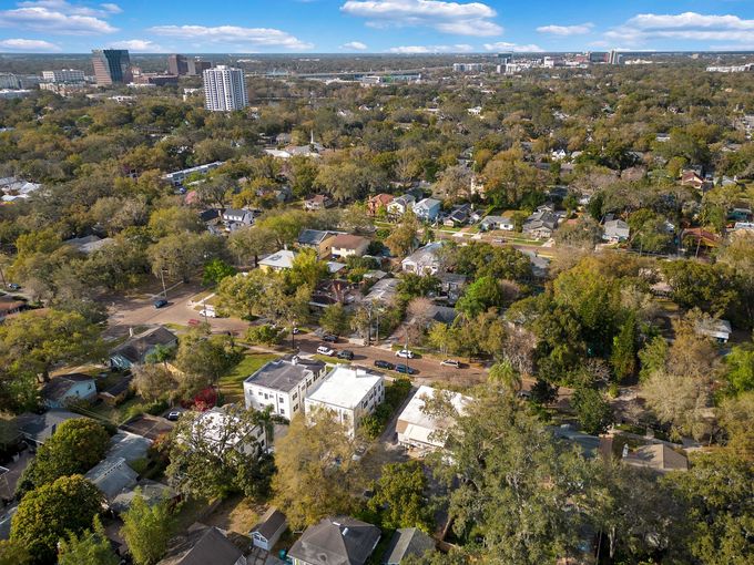 An aerial view of a residential area filled with lots of trees and houses.