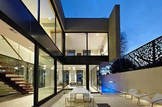 A Modern House With a Patio and a Table and Chairs in Front of It — Leemark Design Services In Parramatta Park, QLD