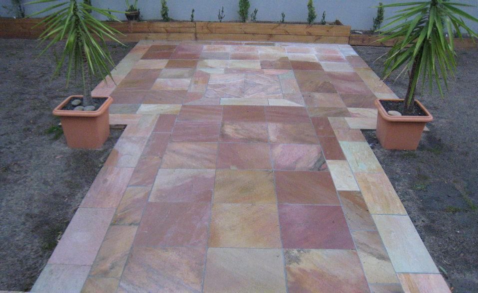 A Stone Walkway With Two Potted Plants On The Side — Leemark Design Services In Parramatta Park, QLD