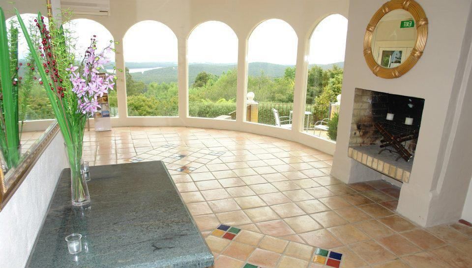 A Living Room With A Fireplace And A Vase Of Flowers On A Table — Leemark Design Services In Parramatta Park, QLD
