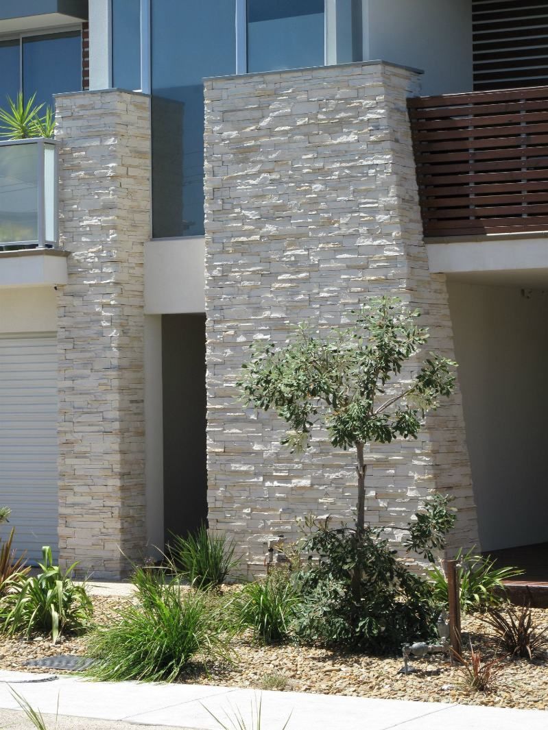 A Brick Building With A Tree In Front Of It — Leemark Design Services In Parramatta Park, QLD