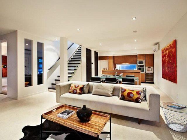 A Living Room With a Couch and a Coffee Table — Leemark Design Services In Parramatta Park, QLD