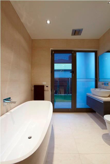 A Bathroom With a Tub a Sink and a Toilet — Leemark Design Services In Parramatta Park, QLD