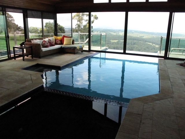 A Large Room With a Swimming Pool and a Couch — Leemark Design Services In Parramatta Park, QLD