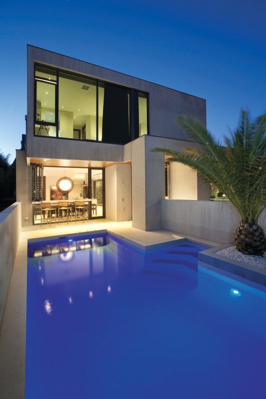 A House With a Large Swimming Pool in Front of It — Leemark Design Services In Parramatta Park, QLD