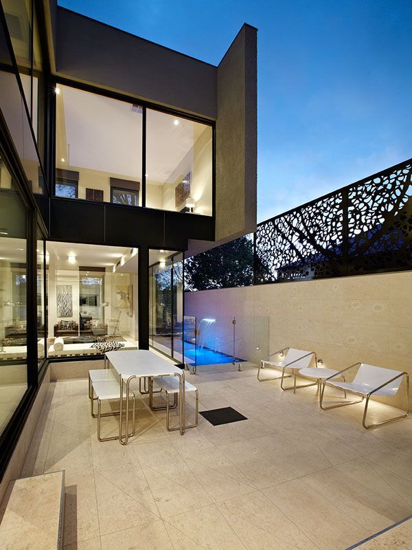 A Patio With a Table and Chairs in Front of a House — Leemark Design Services In Parramatta Park, QLD