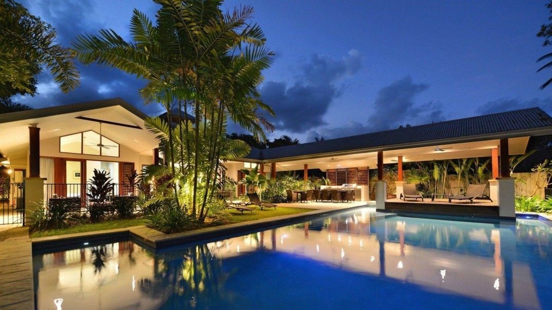A Large House With a Swimming Pool in Front of It — Leemark Design Services In Parramatta Park, QLD