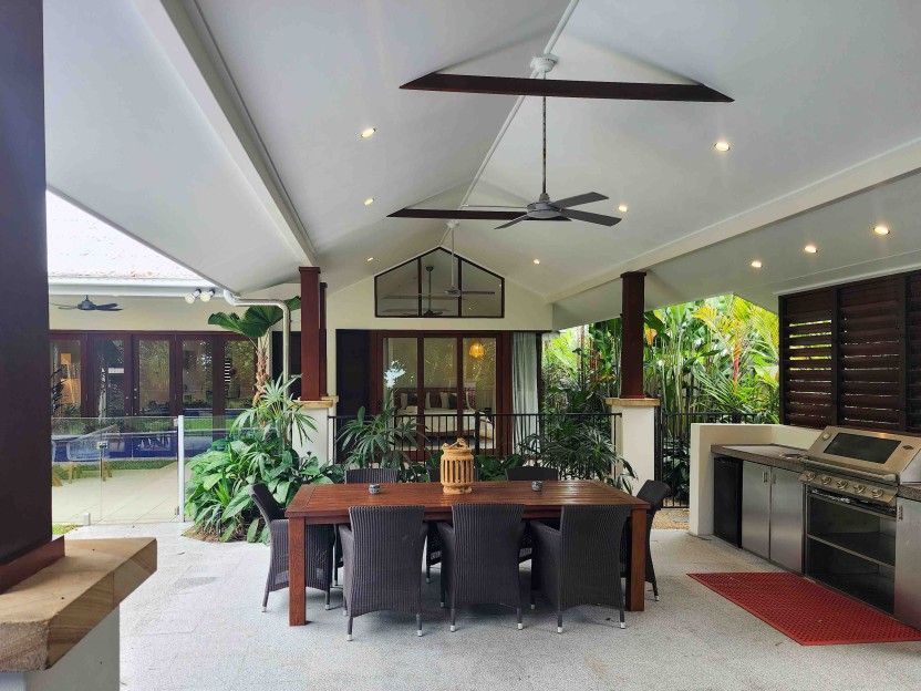 A Patio With a Table and Chairs and a Ceiling Fan — Leemark Design Services In Parramatta Park, QLD