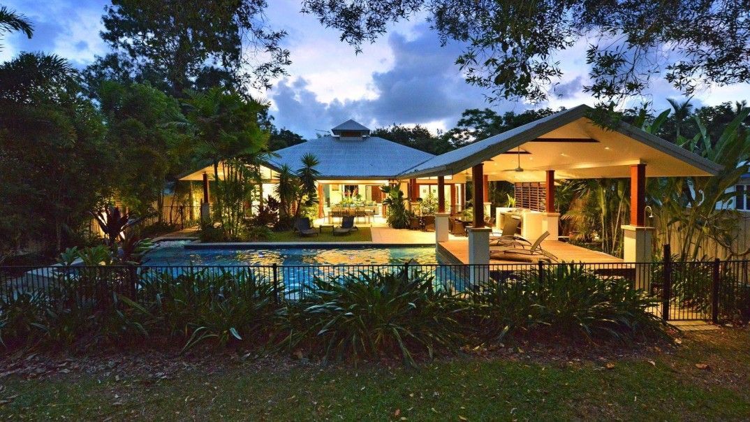 A Large House With a Swimming Pool in Front of It — Leemark Design Services In Parramatta Park, QLD