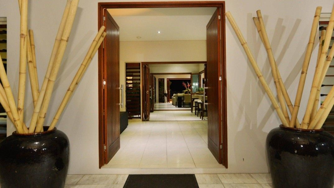A Hallway With Two Vases of Bamboo Sticks in Front of It — Leemark Design Services In Parramatta Park, QLD