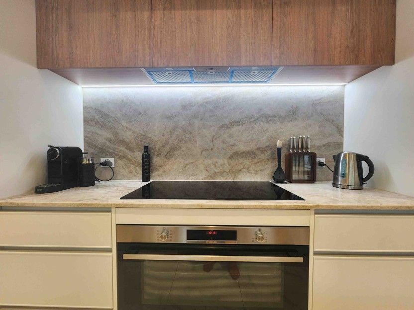 A Kitchen With a Stove, Oven, and Utensils on the Counter — Leemark Design Services In Parramatta Park, QLD