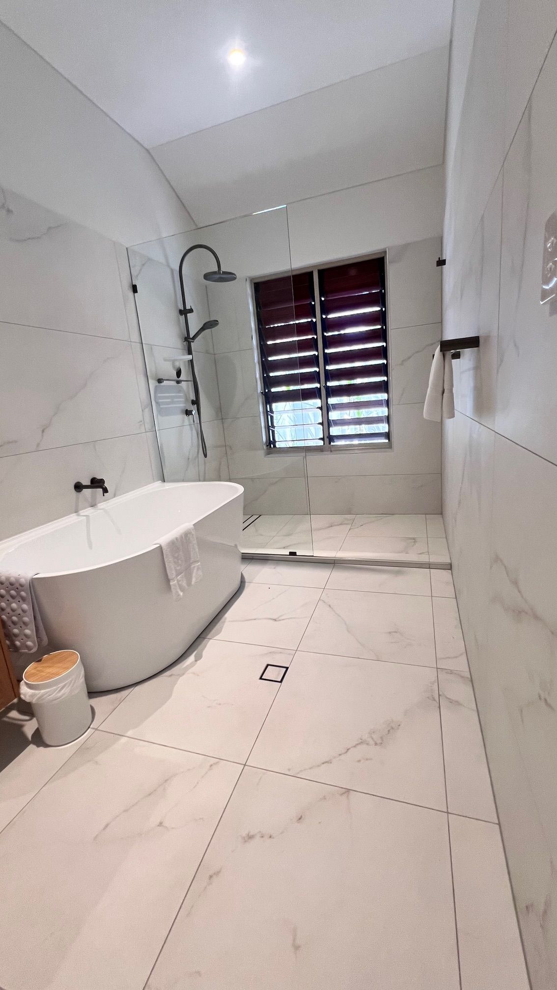 A Bathtub With A Towel On Top Of It In A Bathroom — Leemark Design Services In Parramatta Park, QLD