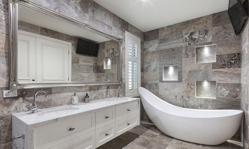 A Bathroom With a Bathtub, Sink and Mirror — Leemark Design Services In Parramatta Park, QLD