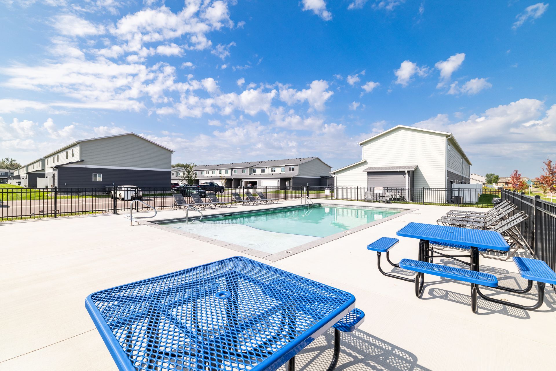 Outdoor pool area with picnic tables.