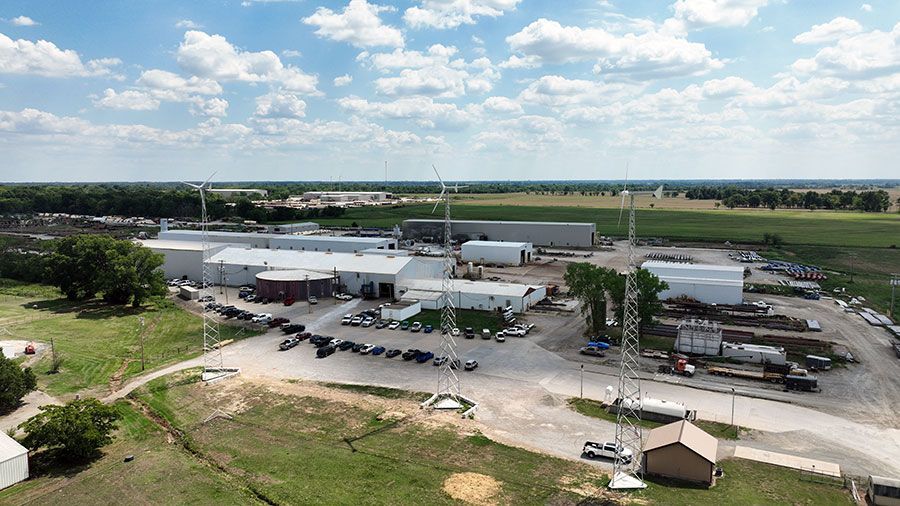 An aerial view of a large industrial area with lots of buildings and trees.