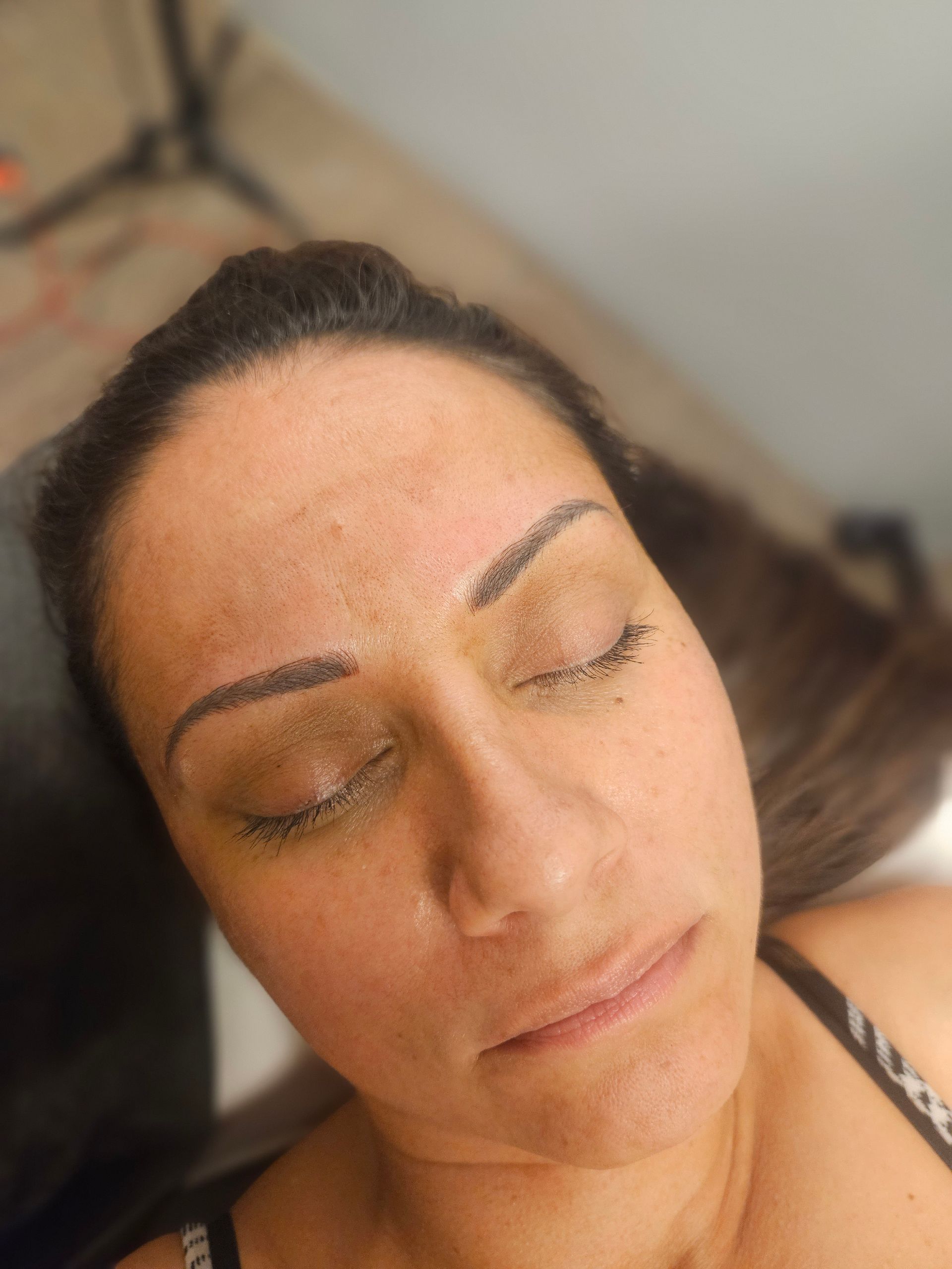 A close up of a woman 's face with her eyes closed.