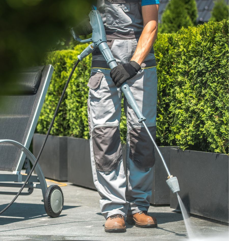 A large orange dumpster filled with wood and paper.