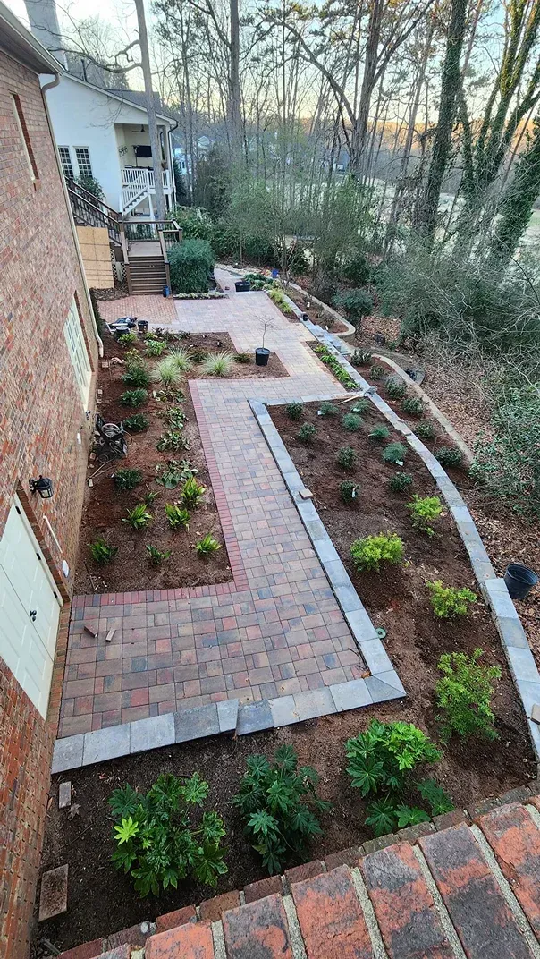 An aerial view of a brick walkway leading to a house.