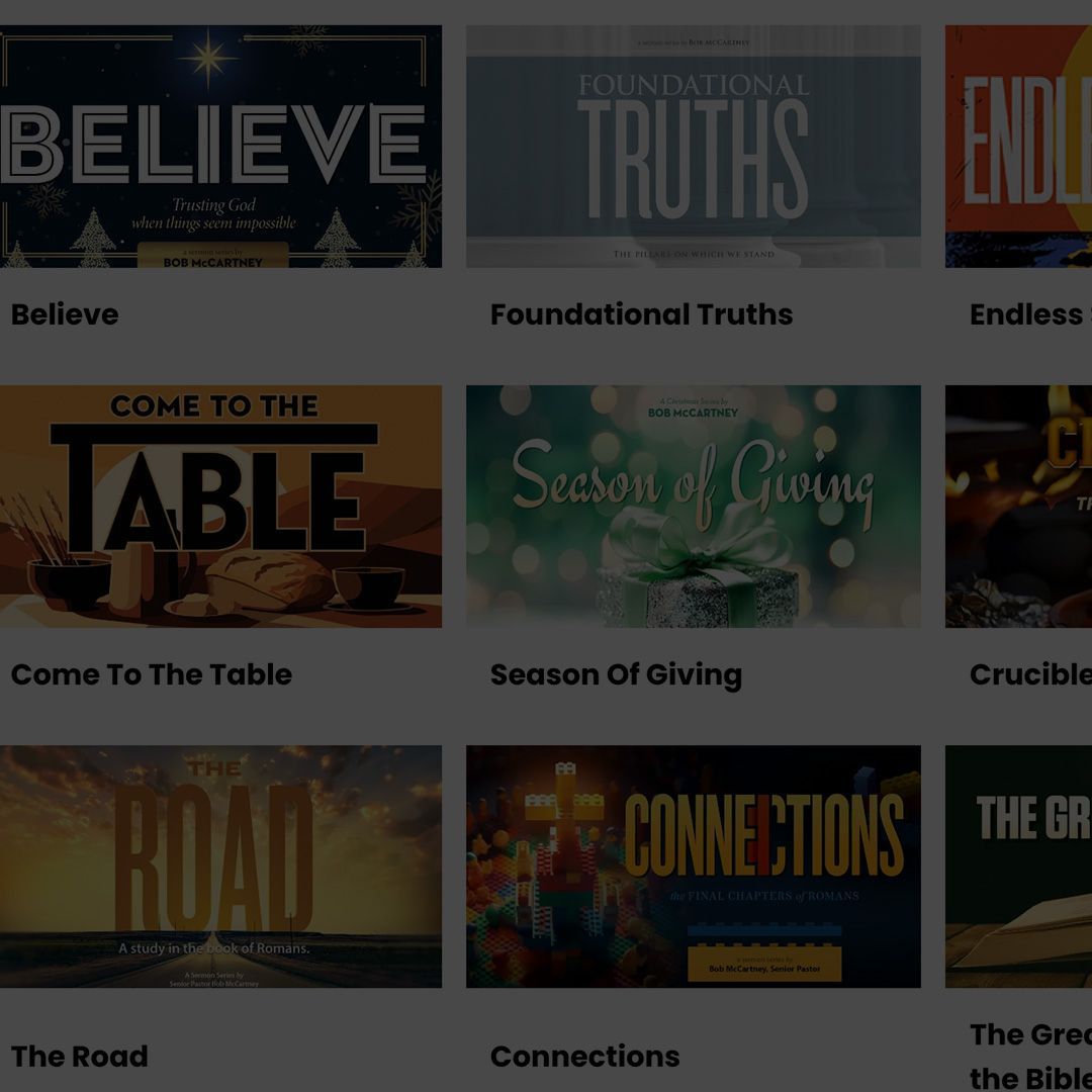 A man is standing at a podium in front of a crowd of people