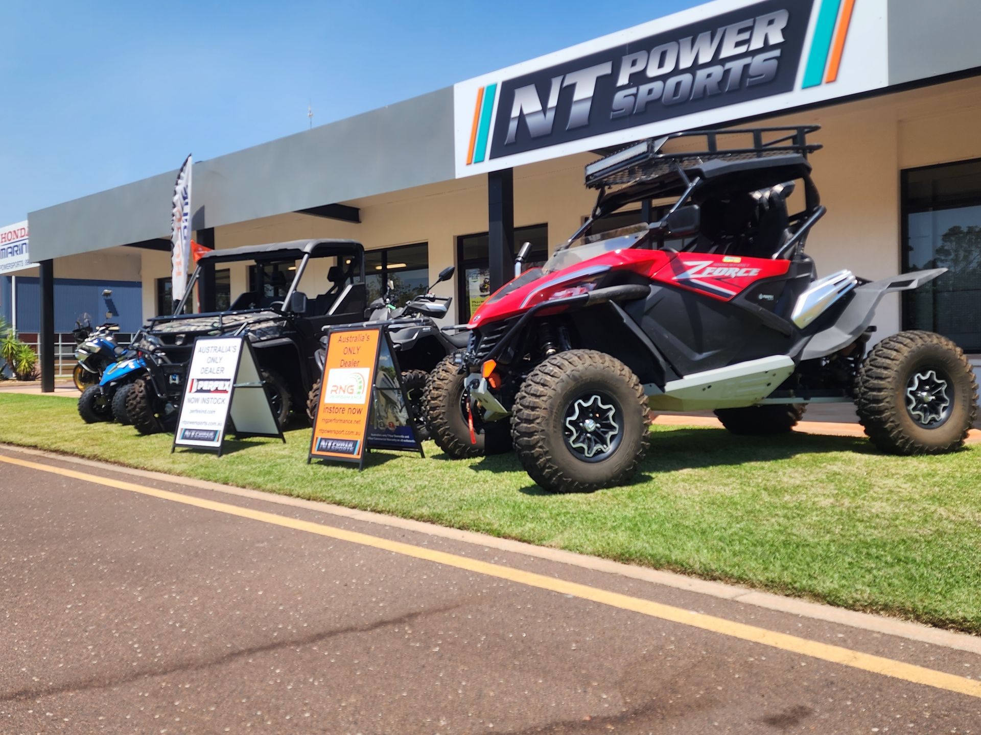 A row of atvs are parked in front of a building.