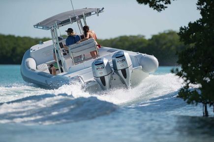 A group of people are riding on the back of a boat in the ocean - Evinrude Outboard Motor In Palmerston, NT