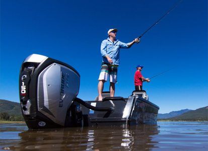 Men Holds Angling - Evinrude Outboard Motor In Yarrawonga, NT