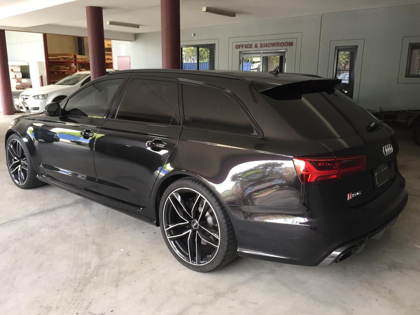 Ceramic tint a black Audi station wagon rear side view
