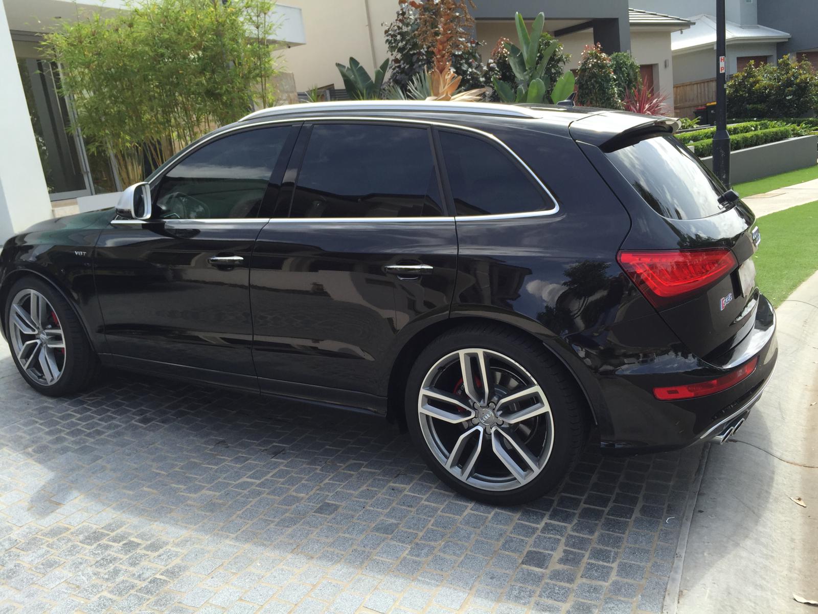 Ceramic tint a black Audi station wagon side view