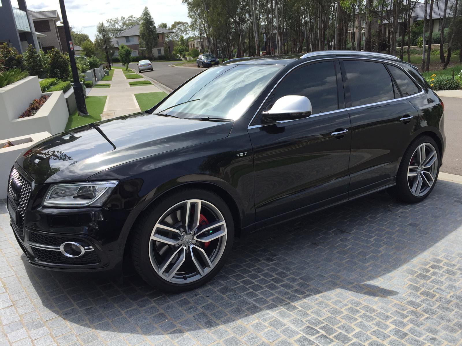 Ceramic tint a black Audi station wagon front view