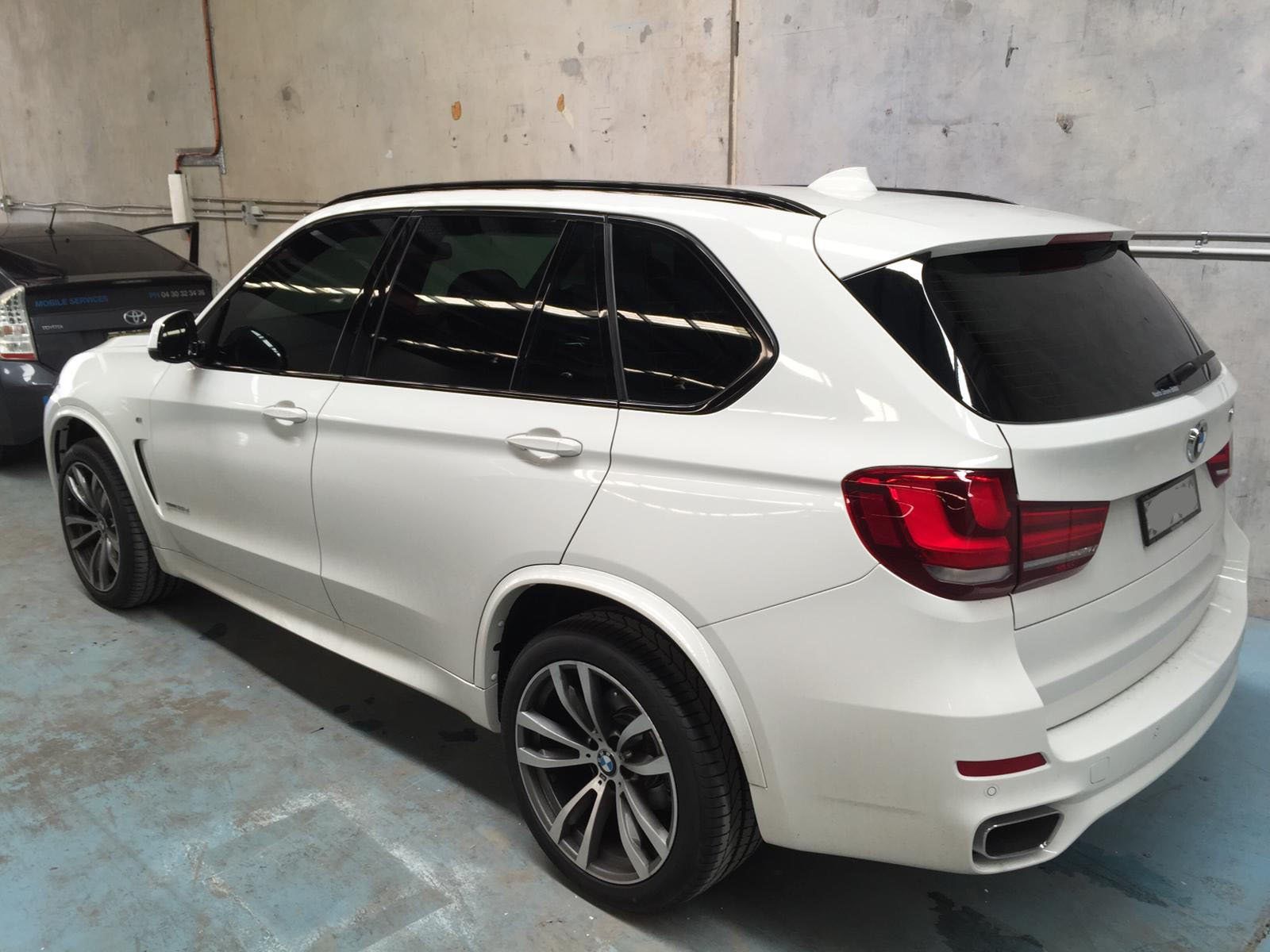 Ceramic tint a white BMW side view