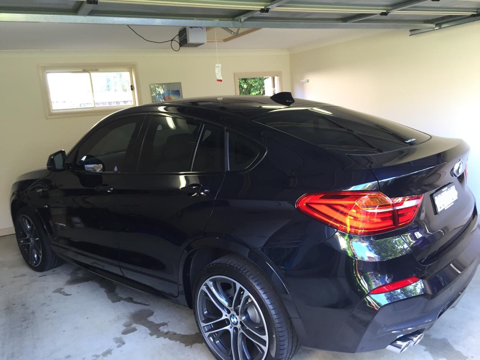 Ceramic tint a black BMW X5 rear side view