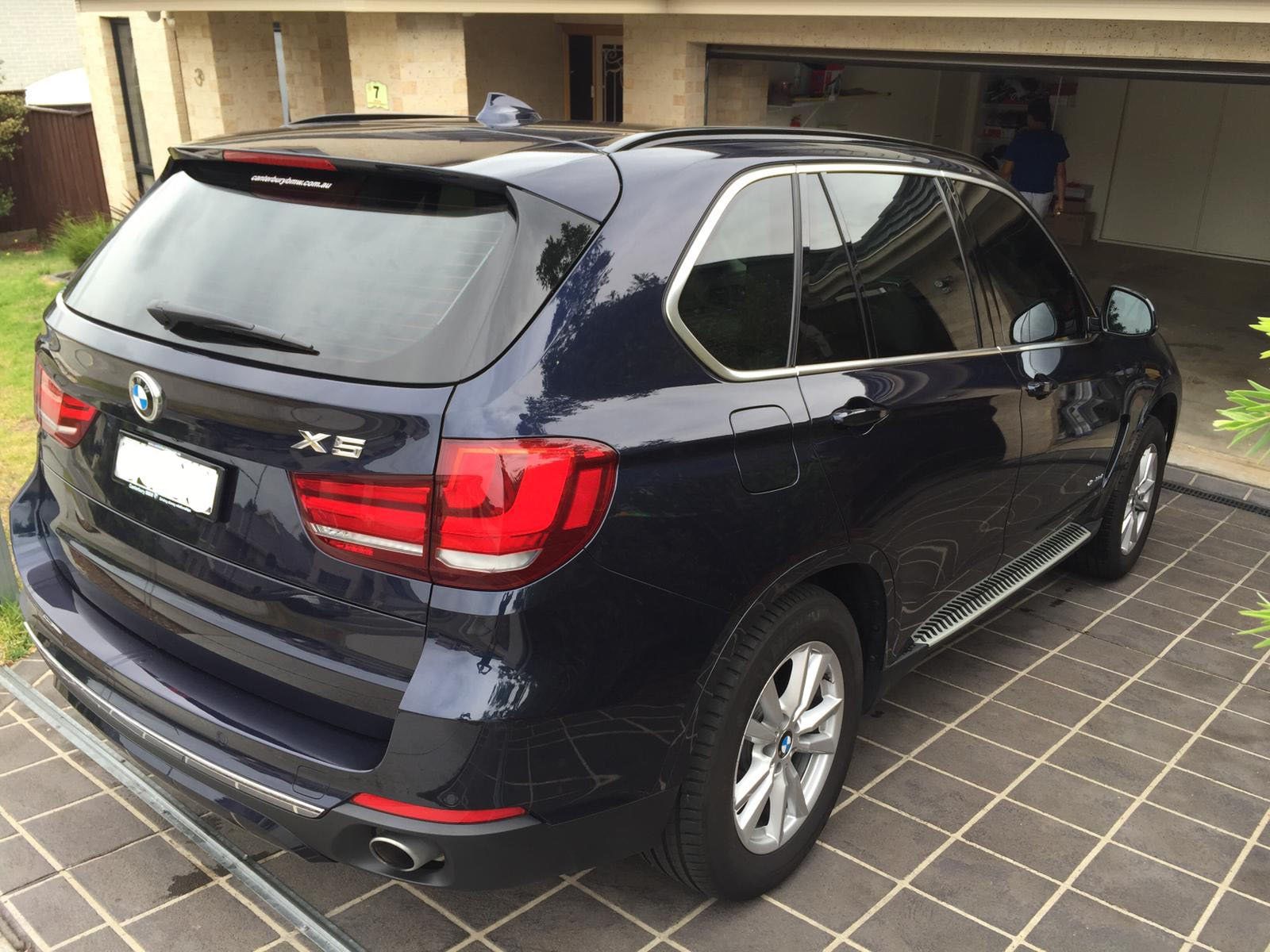 Ceramic tint a black BMW X5 rear view