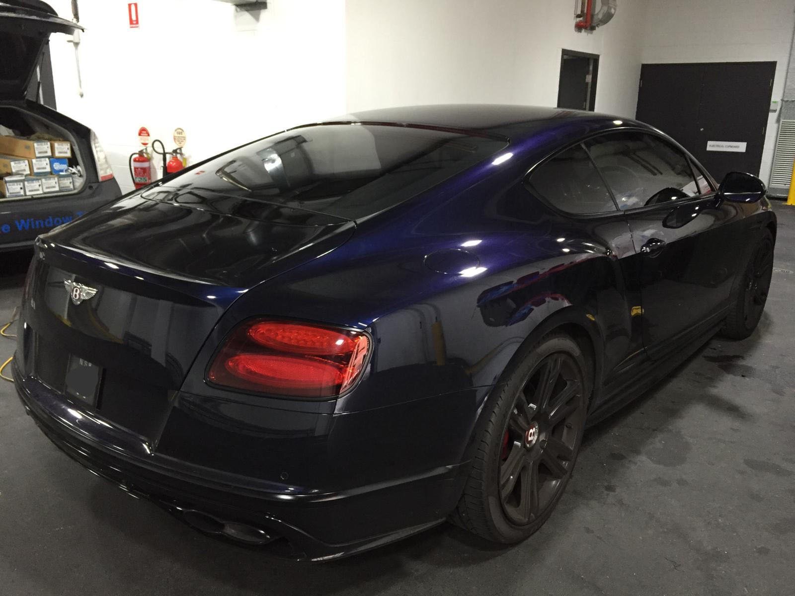 Ceramic tint a black european luxury car rear side view