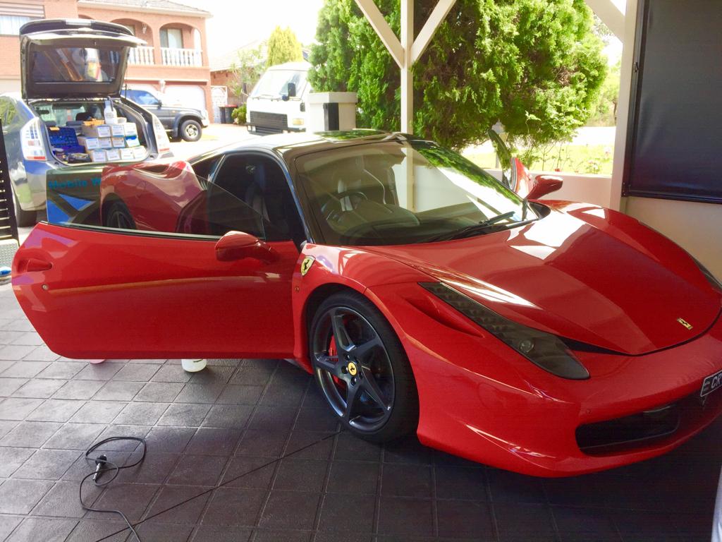 Ceramic tint a red ferrari sports car rear view