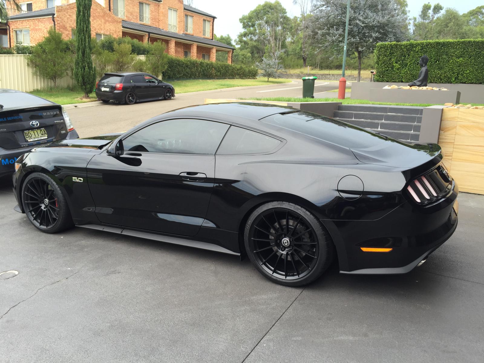 Ceramic tint a grey Ford Mustang side view