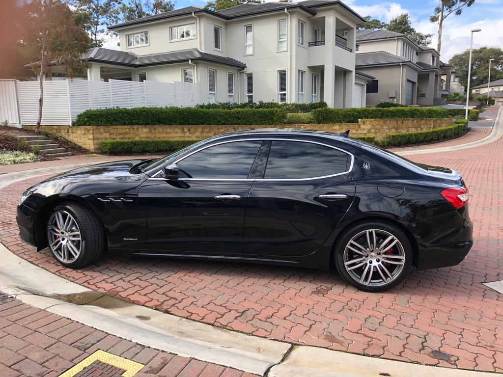 Ceramic tint a black Maserati sports side view