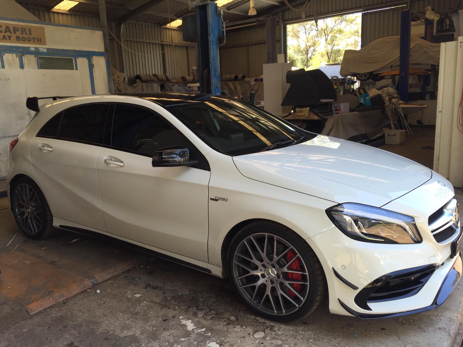 Ceramic tint a white Mercedes AMG sports side view
