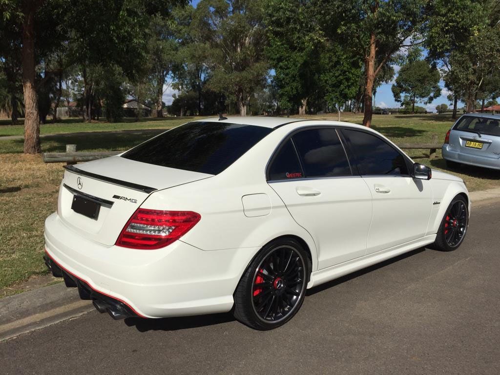 Ceramic tint a white Mercedes C63 rear side view