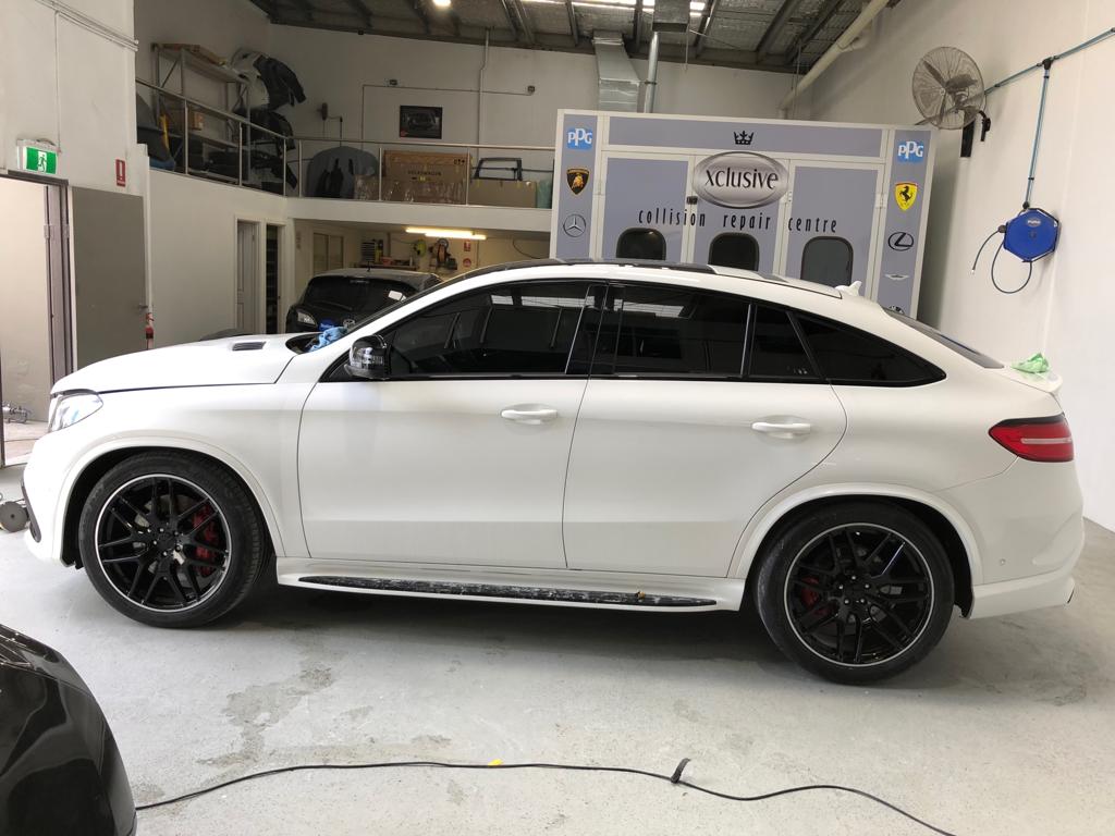 Ceramic tint a white Mercedes side view